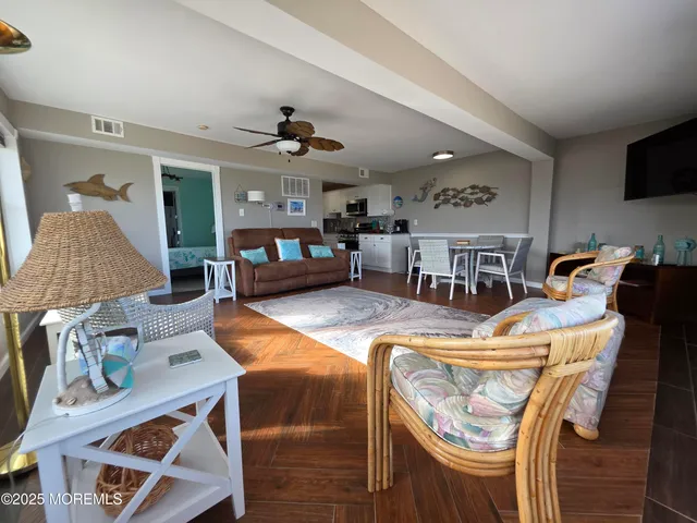 a living room with furniture and flat screen tv
