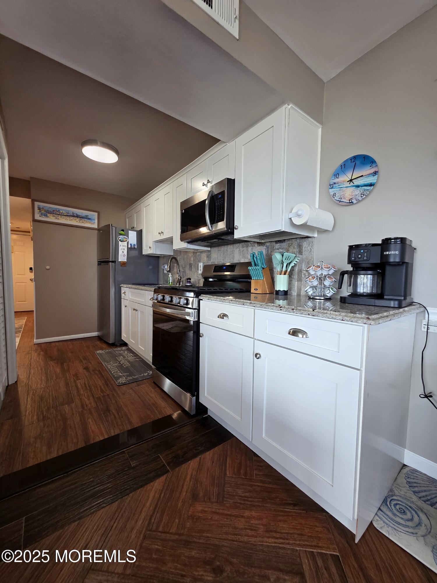 42 Dune Terrace Seaside Heights, NJ 08751 - Photo 6 of 17 a kitchen with stainless steel appliances granite countertop a stove a sink dishwasher and a refrigerator