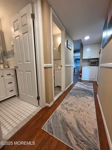 a view of kitchen with refrigerator microwave and cabinets