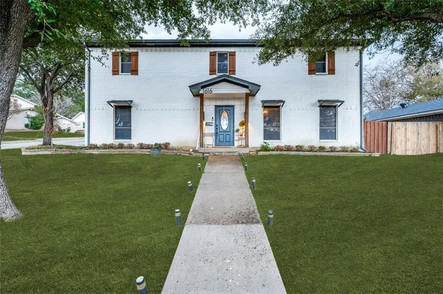 front view of a house with a garden