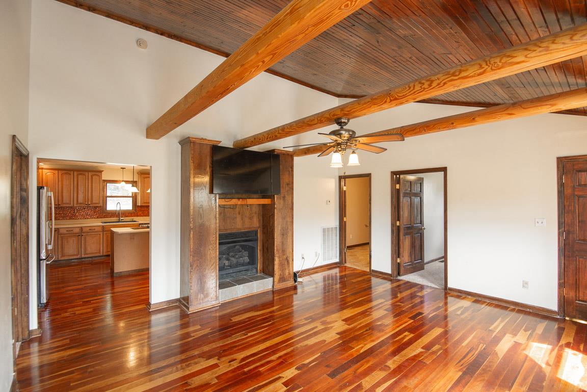 101 Spring Creek Road Waverly, TN 37185 - Photo 3 of 30 Great Room with Fireplace, Beautiful Wood Cathedral Ceiling, Gorgeous Cherry Hardwood Floors & Wood Beams