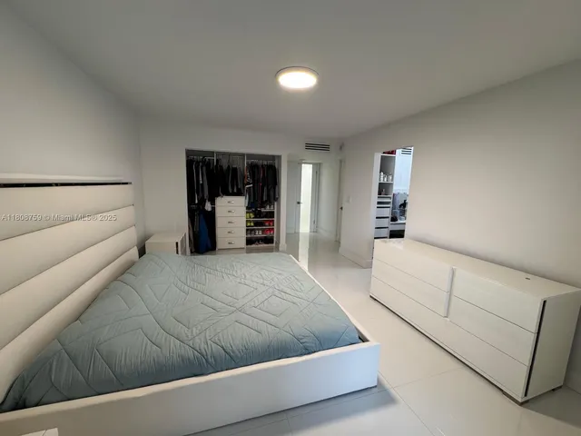 a living room with furniture and walk in closet