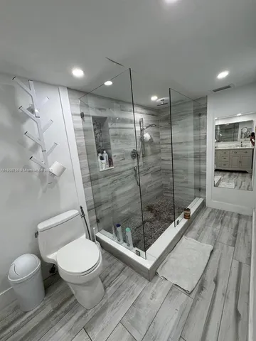 a bathroom with a toilet a sink and shower