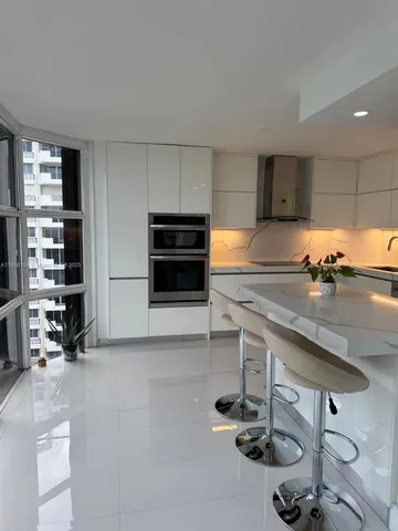 a kitchen with a sink a stove and a refrigerator