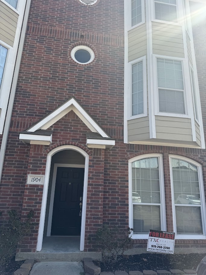 Entrance to property with brick siding