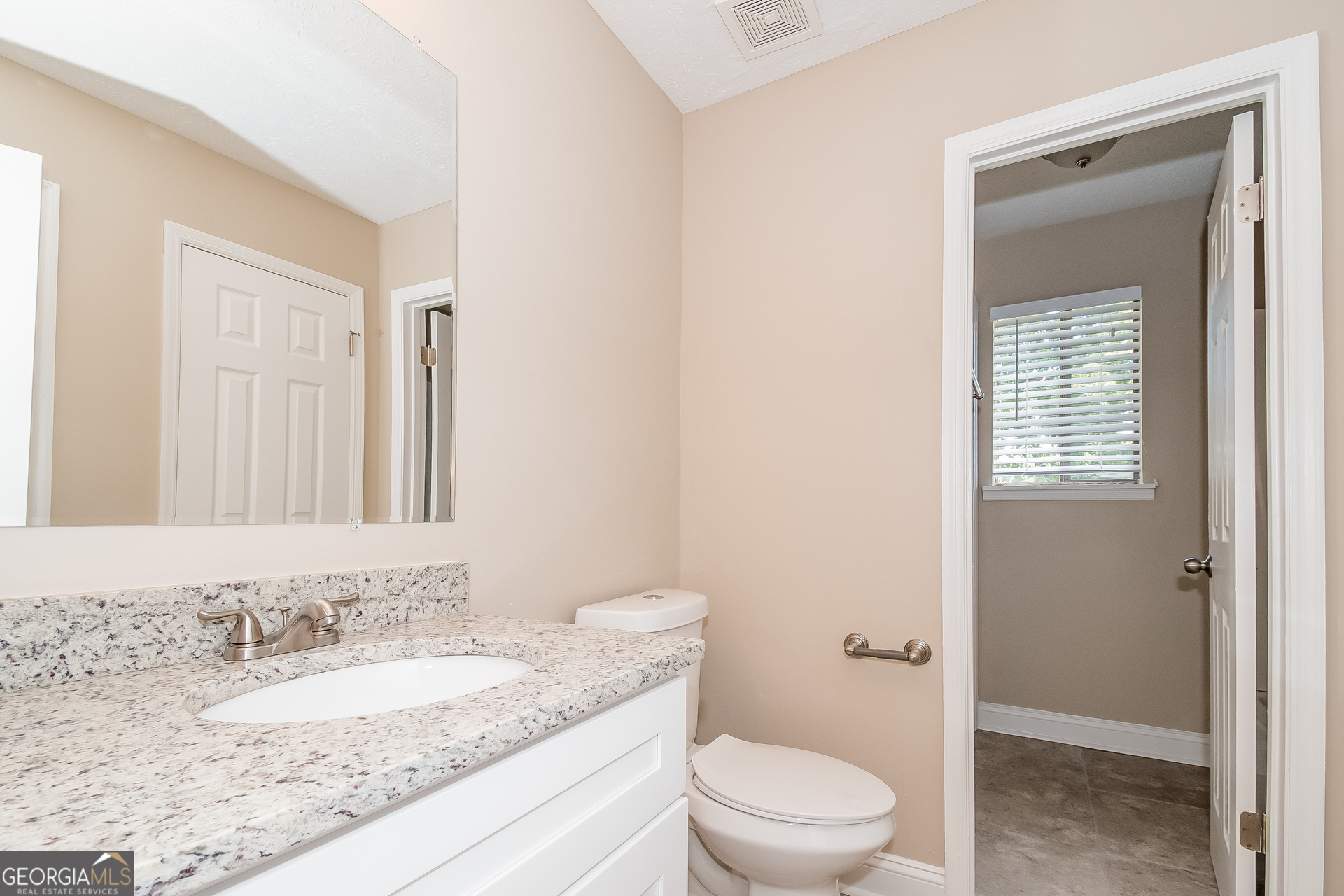 2264 Rocklane Drive Conley, GA 30288 - Photo 14 of 15 a bathroom with a granite countertop sink a toilet and a shower
