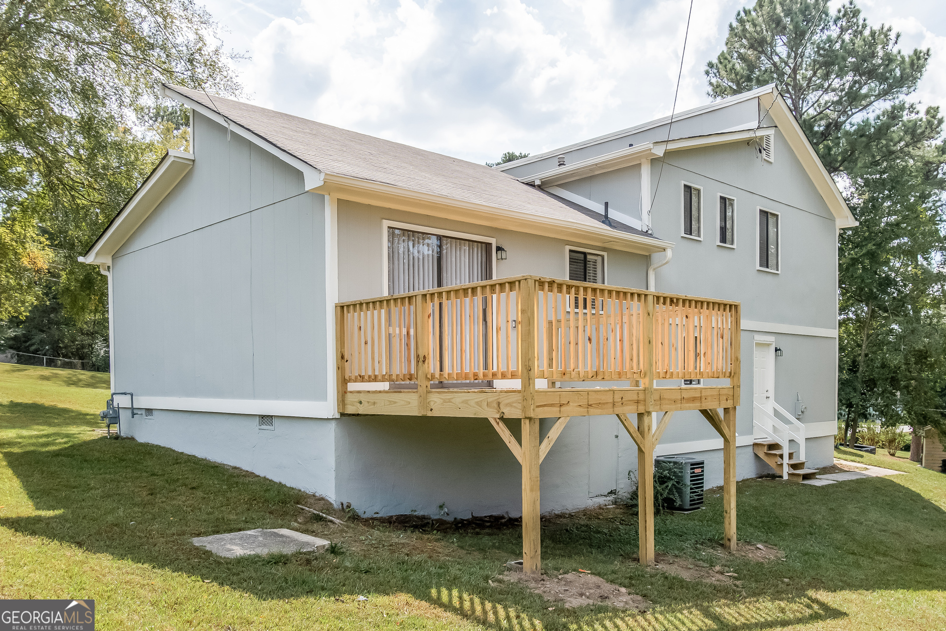 2264 Rocklane Drive Conley, GA 30288 - Photo 15 of 15 a view of a patio with table and chairs with wooden fence