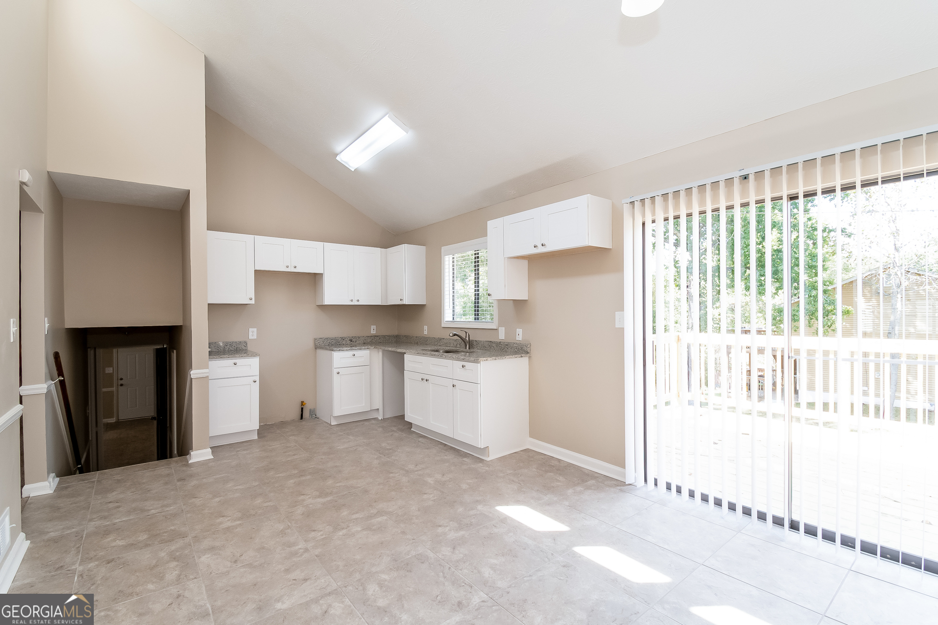 2264 Rocklane Drive Conley, GA 30288 - Photo 5 of 15 a kitchen with a refrigerator and window