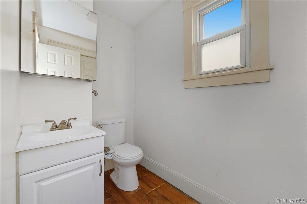 22 Sunset Trail, Unit 22 Bronx, NY 10465 - Photo 12 of 21 a bathroom with a toilet sink vanity and mirror