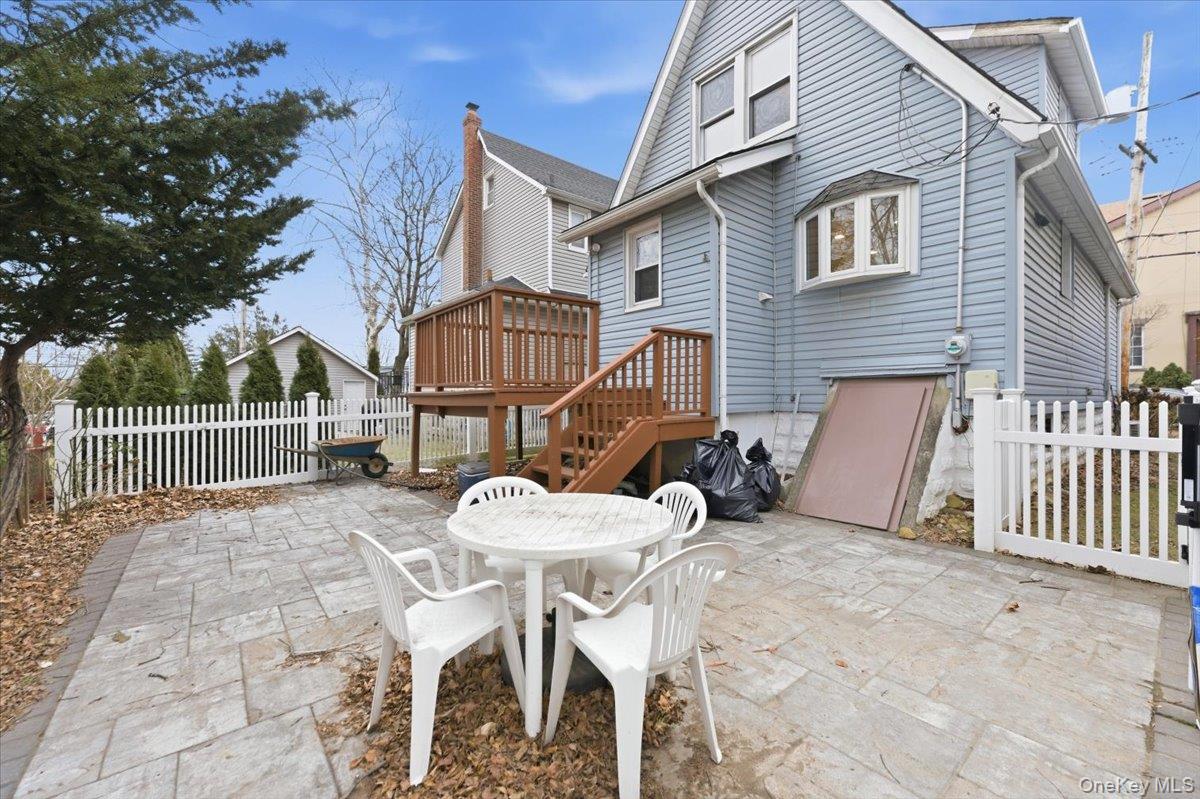 22 Sunset Trail, Unit 22 Bronx, NY 10465 - Photo 18 of 21 a view of a chair and table in the back yard of the house