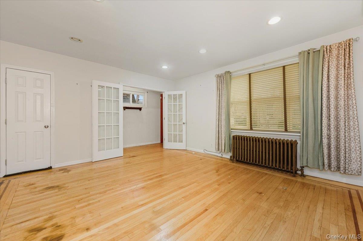 22 Sunset Trail, Unit 22 Bronx, NY 10465 - Photo 2 of 21 a view of an empty room with wooden floor and a window