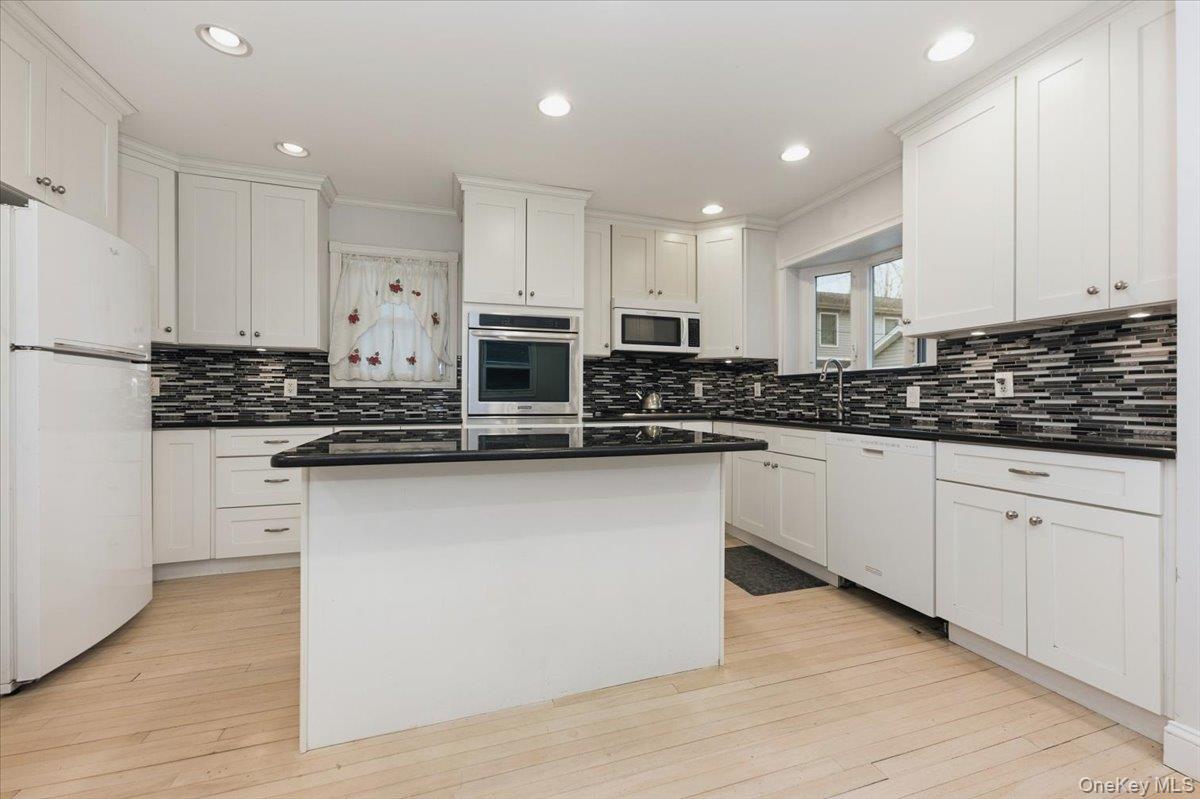 22 Sunset Trail, Unit 22 Bronx, NY 10465 - Photo 6 of 21 a kitchen with stainless steel appliances granite countertop a stove a sink and white cabinets