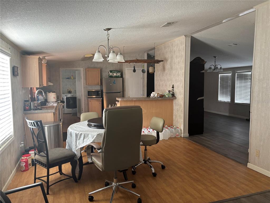 7117 South County Line Road Plant City, FL 33567 - Photo 3 of 15 a view of a dining room with furniture window and wooden floor