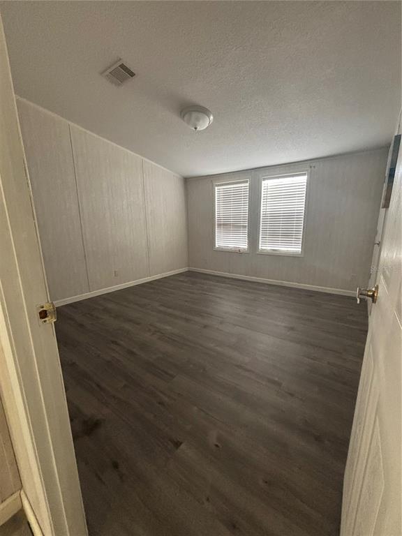7117 South County Line Road Plant City, FL 33567 - Photo 5 of 15 an empty room with wooden floor and windows