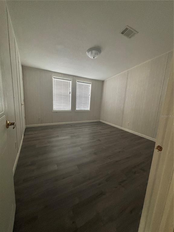 7117 South County Line Road Plant City, FL 33567 - Photo 6 of 15 an empty room with wooden floor and windows