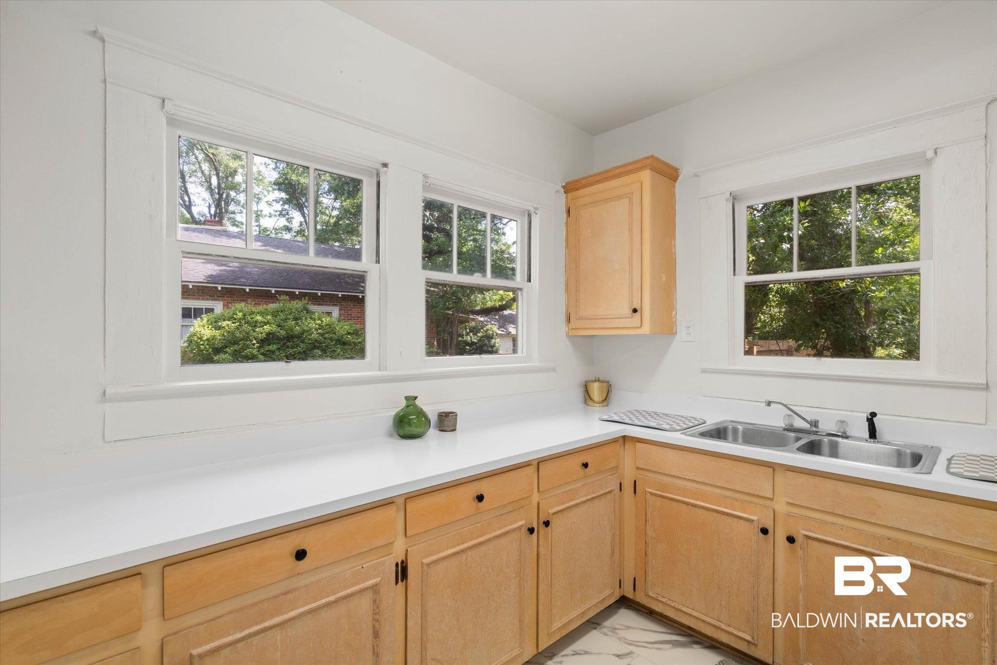 121 Westwood Street Mobile, AL 36606 - Photo 7 of 20 Kitchen featuring a wealth of natural light, light countertops, marble finish floor, and a sink