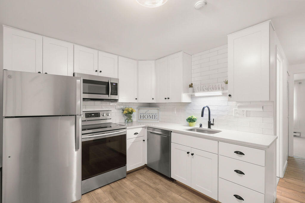17 Highview Drive, Unit 17 Sandwich, MA 02563 - Photo 3 of 32 a kitchen with white cabinets and white appliances
