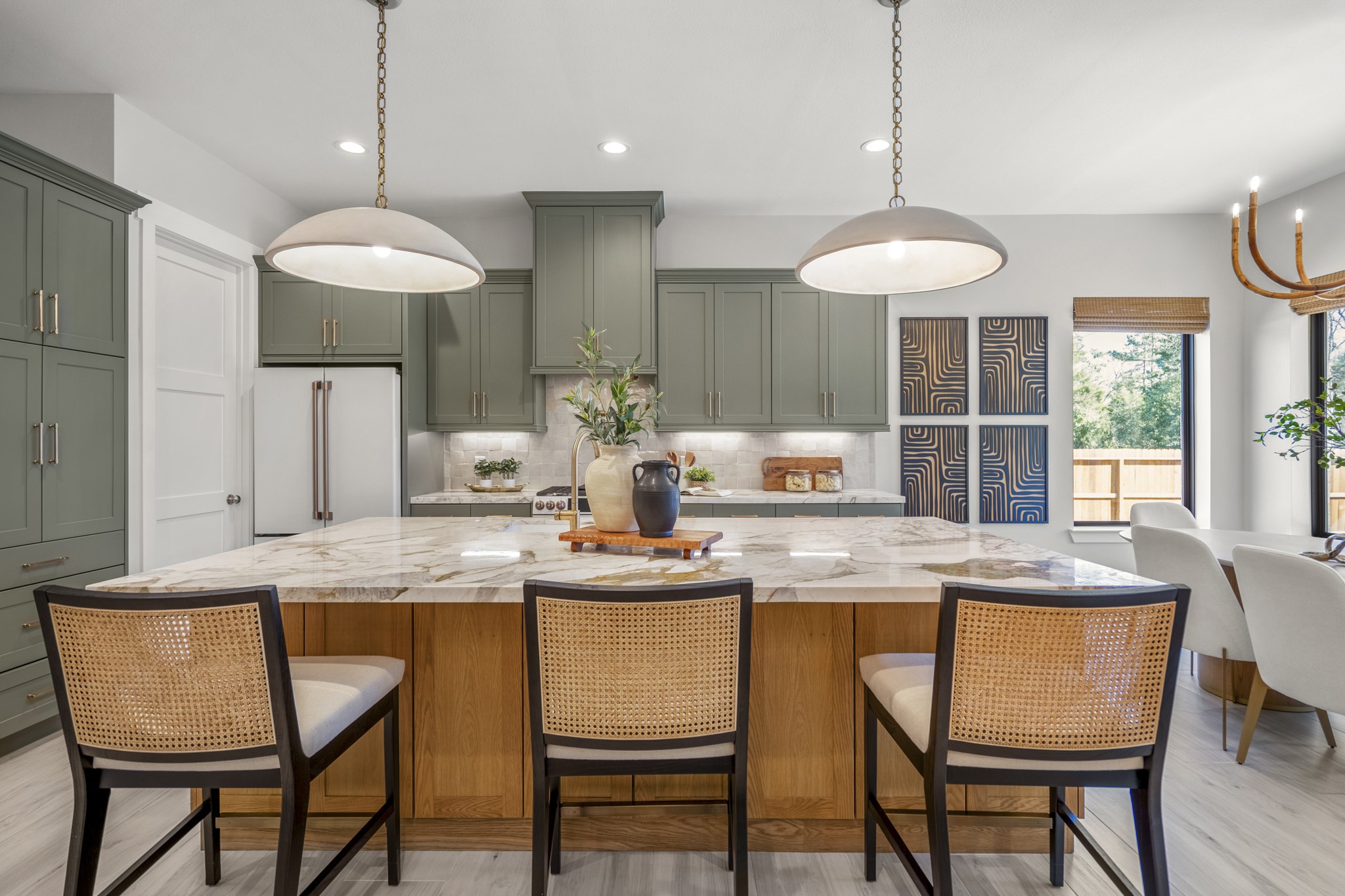 21255 Hidden Bend Loop Magnolia, TX 77354 - Photo 13 of 44 a kitchen with a dining table and chandelier
