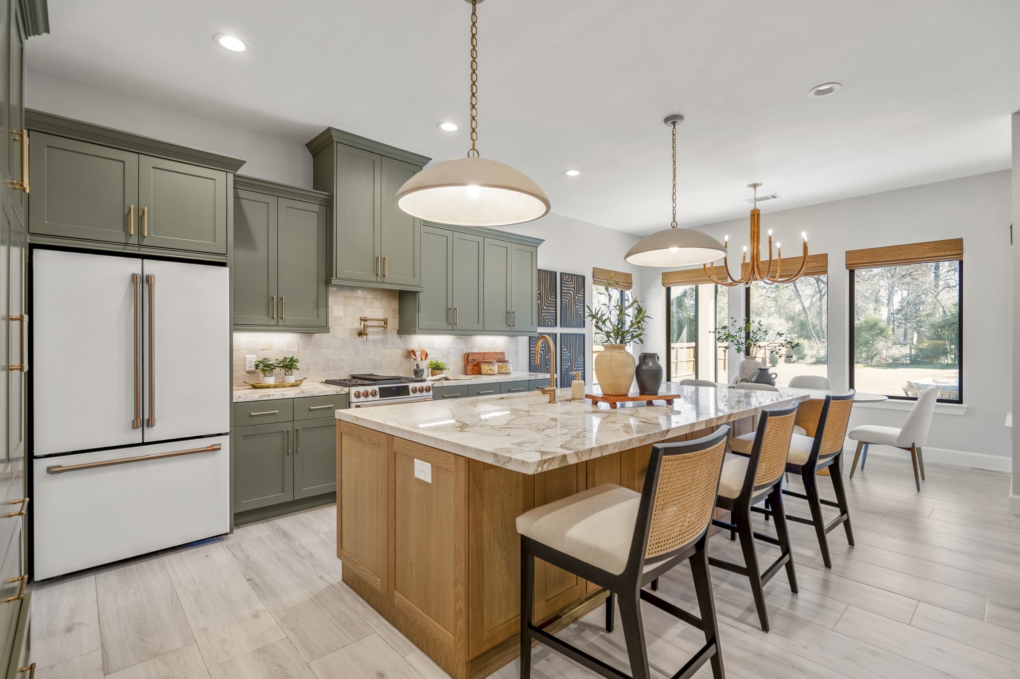 21255 Hidden Bend Loop Magnolia, TX 77354 - Photo 14 of 44 a kitchen with stainless steel appliances granite countertop a stove a refrigerator a kitchen island a dining table and chairs
