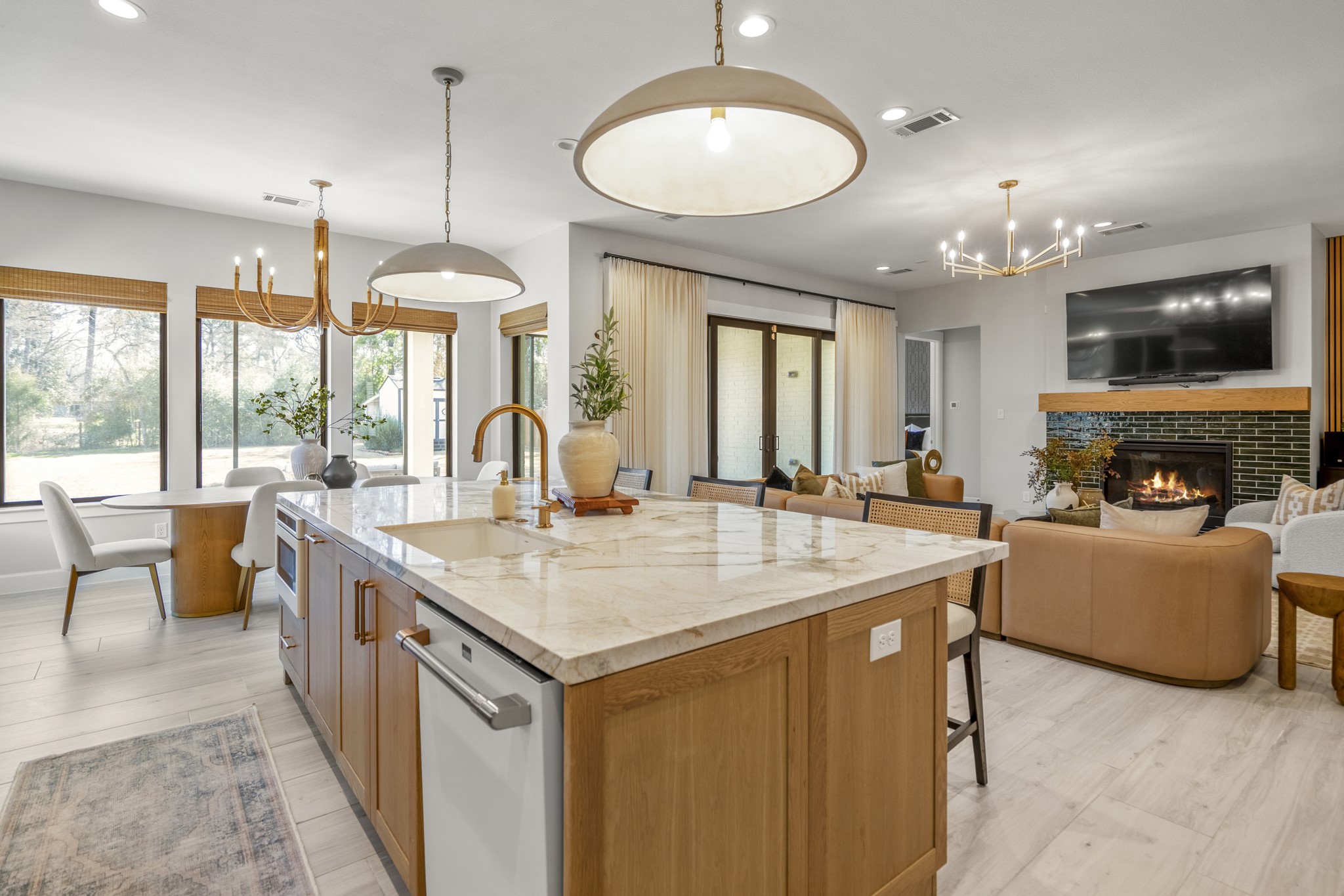 21255 Hidden Bend Loop Magnolia, TX 77354 - Photo 15 of 44 a view of living room kitchen with a sink and dishwasher a fireplace with large windows