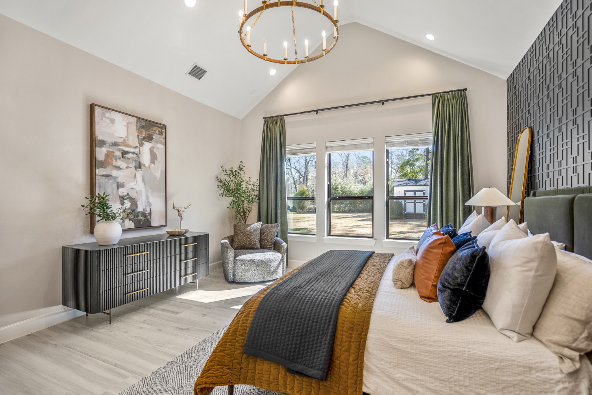 21255 Hidden Bend Loop Magnolia, TX 77354 - Photo 20 of 44 a bedroom with a large bed and a chandelier