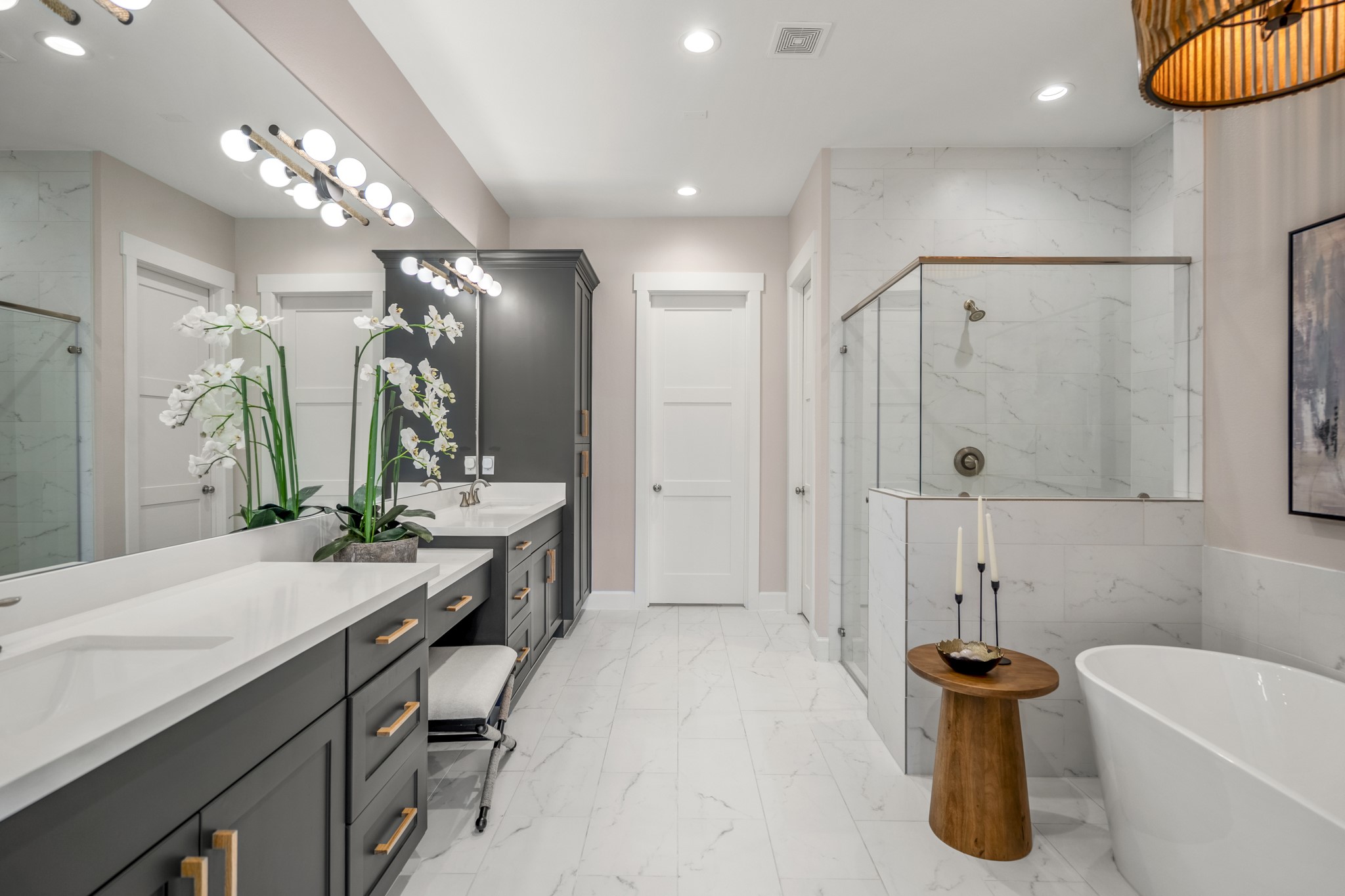 21255 Hidden Bend Loop Magnolia, TX 77354 - Photo 21 of 44 a bathroom with a tub a sink and a large mirror