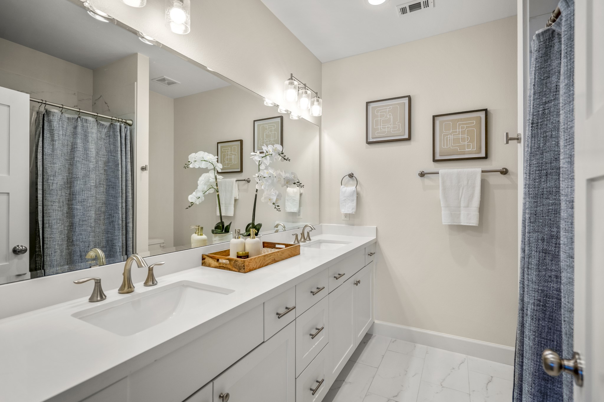 21255 Hidden Bend Loop Magnolia, TX 77354 - Photo 29 of 44 a bathroom with double vanity sink and a mirror