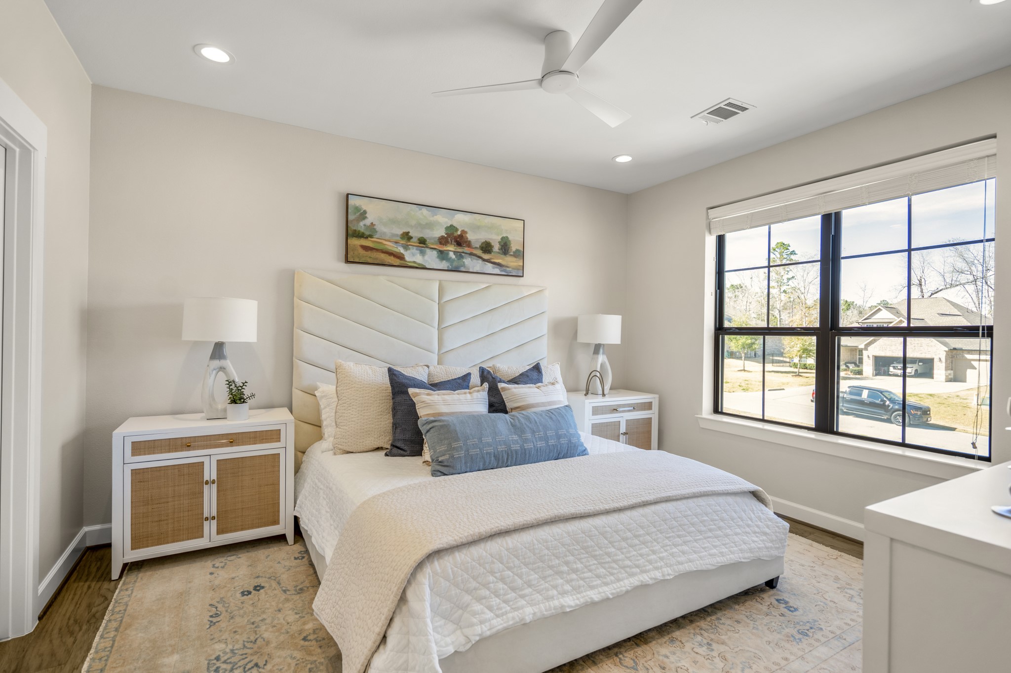 21255 Hidden Bend Loop Magnolia, TX 77354 - Photo 30 of 44 a bedroom with a large bed and a large window