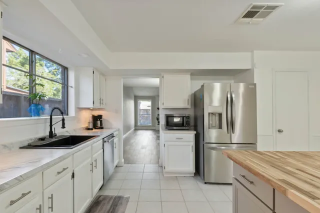 a kitchen with a sink stove and refrigerator