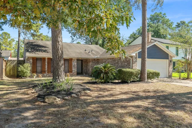 a view of a house with a tree in the background