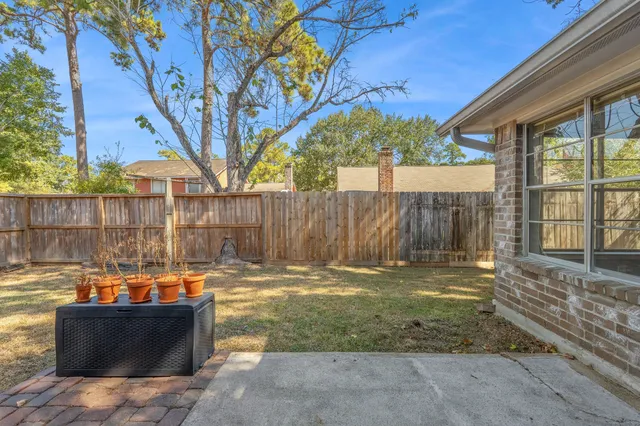a view of a backyard with plants and a patio