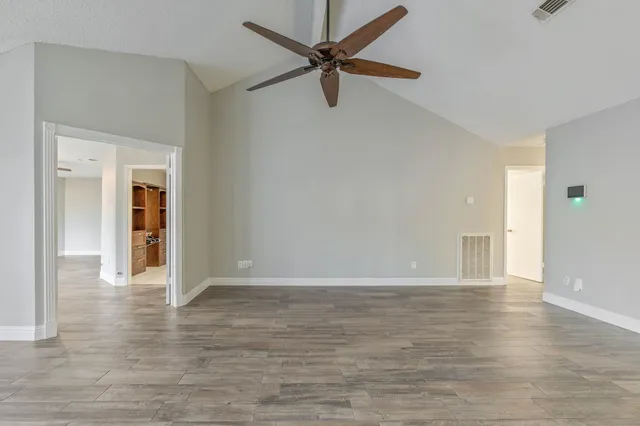 a view of a livingroom with wooden floor and a ceiling fan