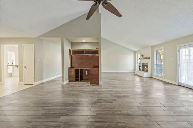 a view of empty room with wooden floor