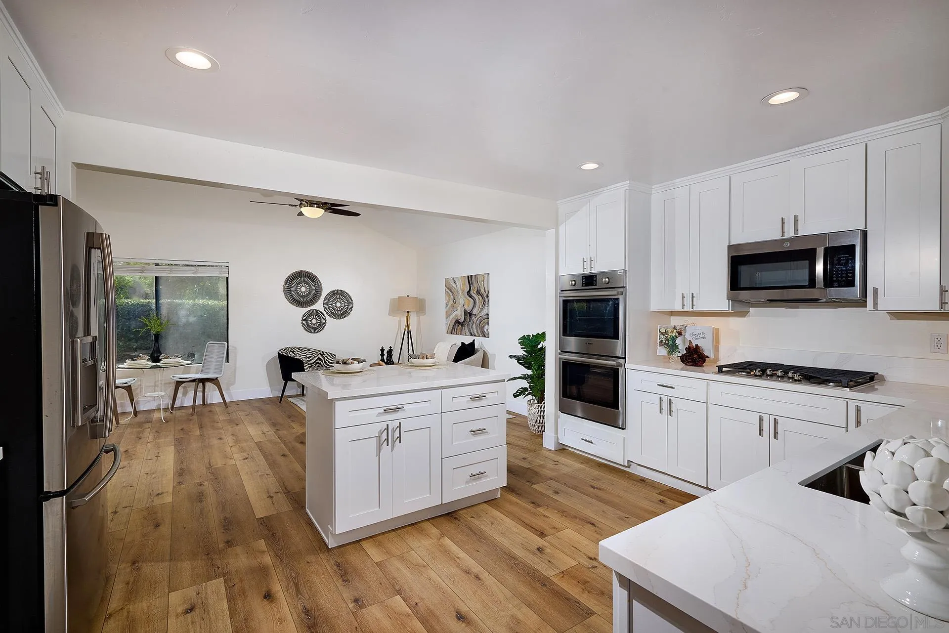 13269 Vinter Way Poway, CA 92064 - Photo 18 of 32 a kitchen with stainless steel appliances kitchen island granite countertop a stove top oven a sink a dining table and chairs