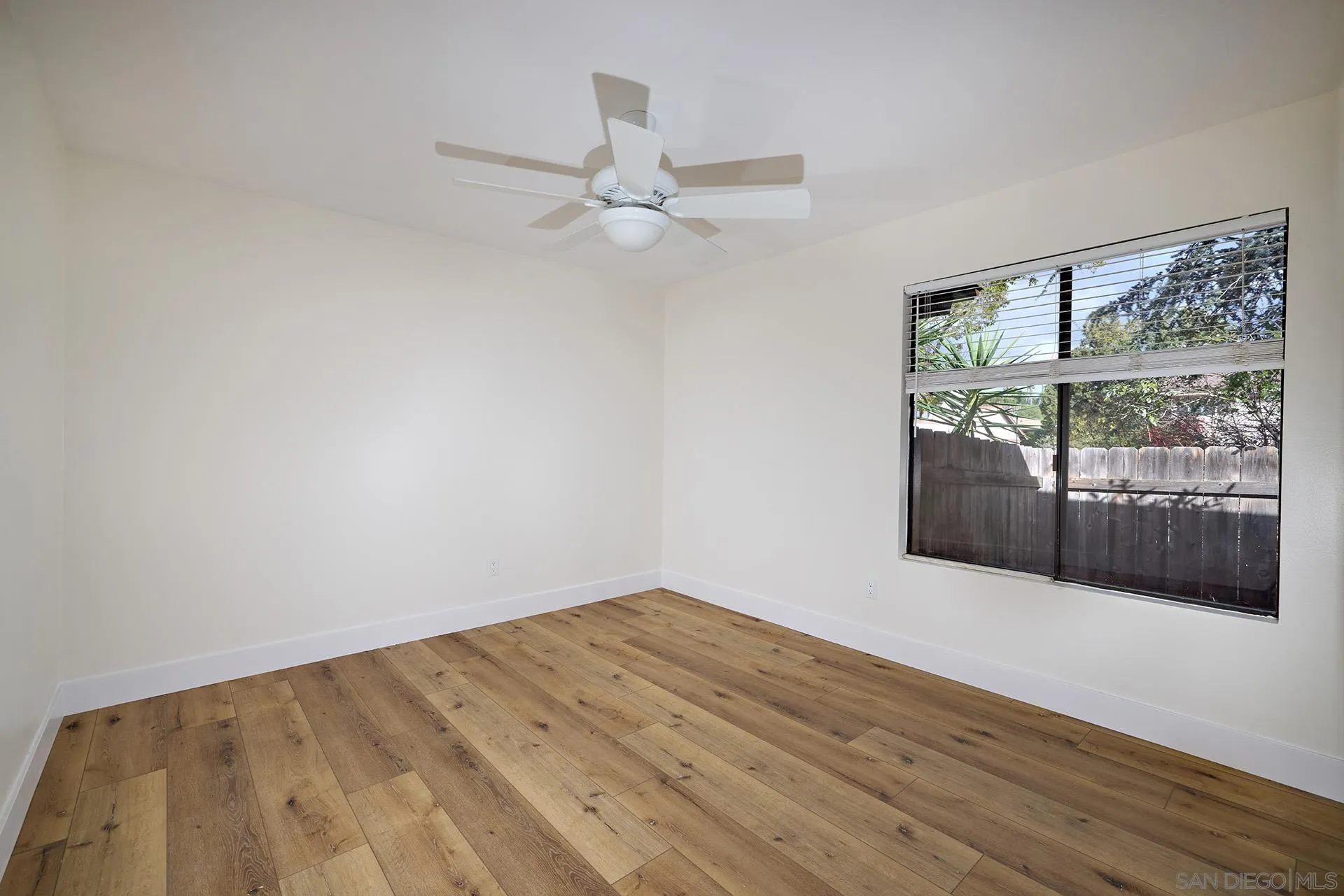 13269 Vinter Way Poway, CA 92064 - Photo 28 of 32 an empty room with wooden floor and fan