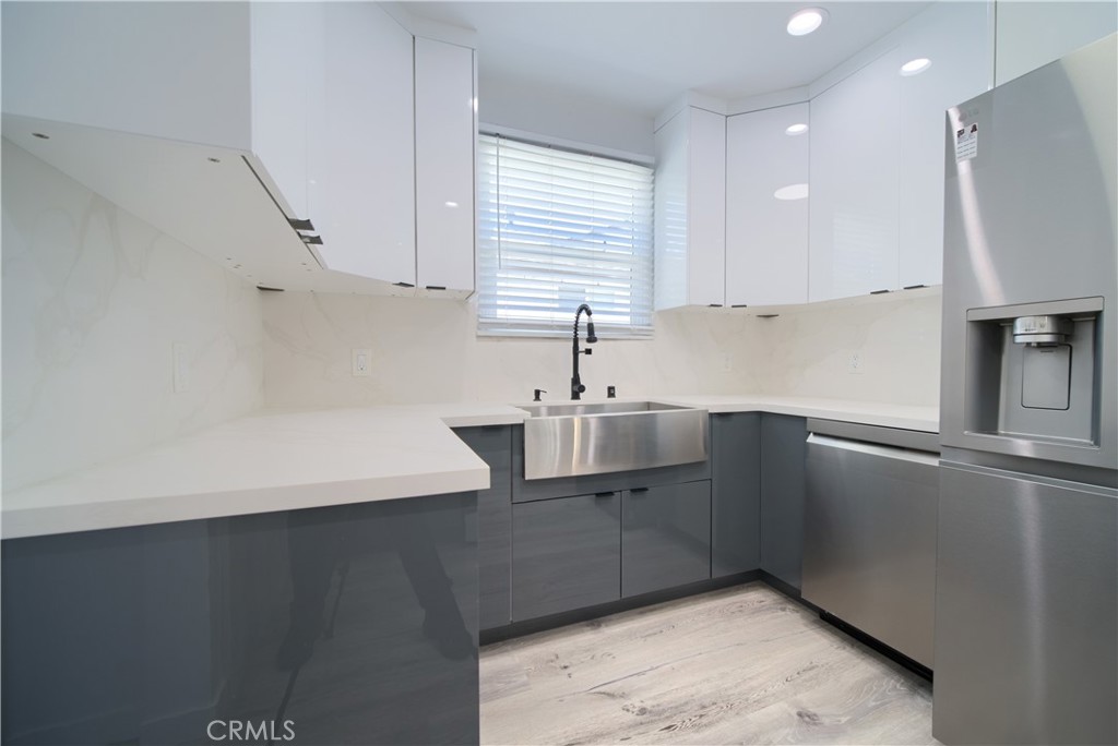6160 Shoshone Avenue Encino, CA 91316 - Photo 12 of 22 a kitchen with stainless steel appliances a sink a stove a refrigerator and cabinets