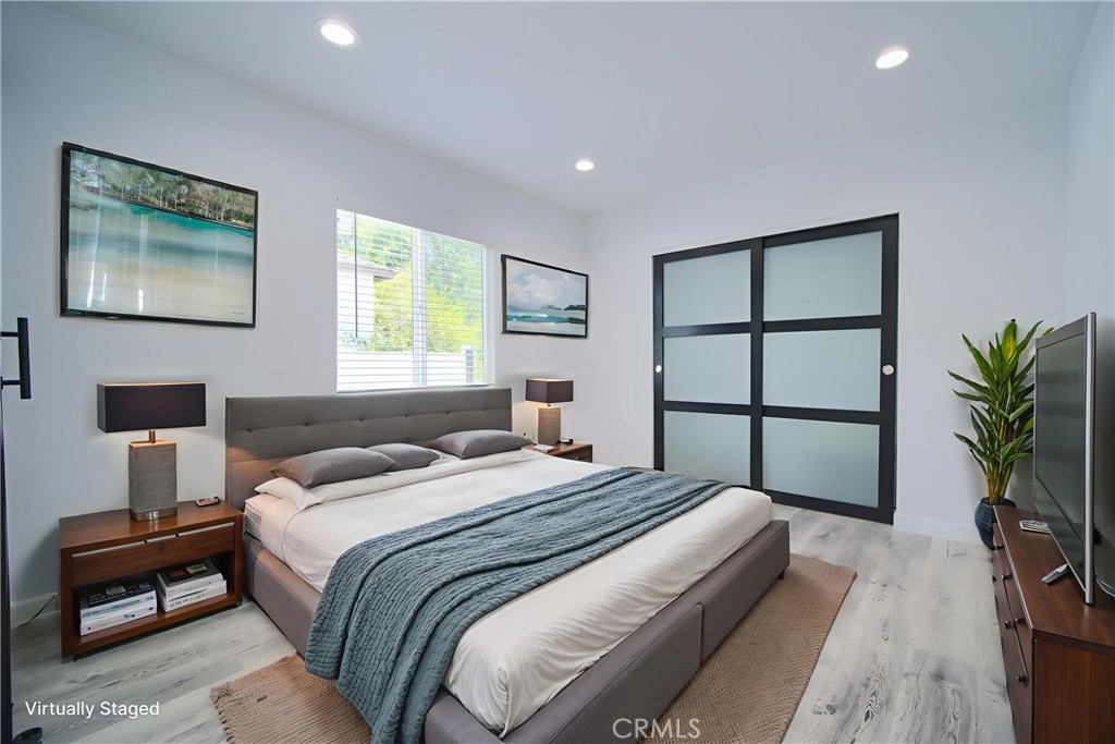 6160 Shoshone Avenue Encino, CA 91316 - Photo 6 of 22 a bedroom with a large bed and a potted plant