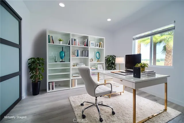 a work room with furniture and a potted plant