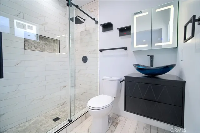 a bathroom with a toilet and a shower