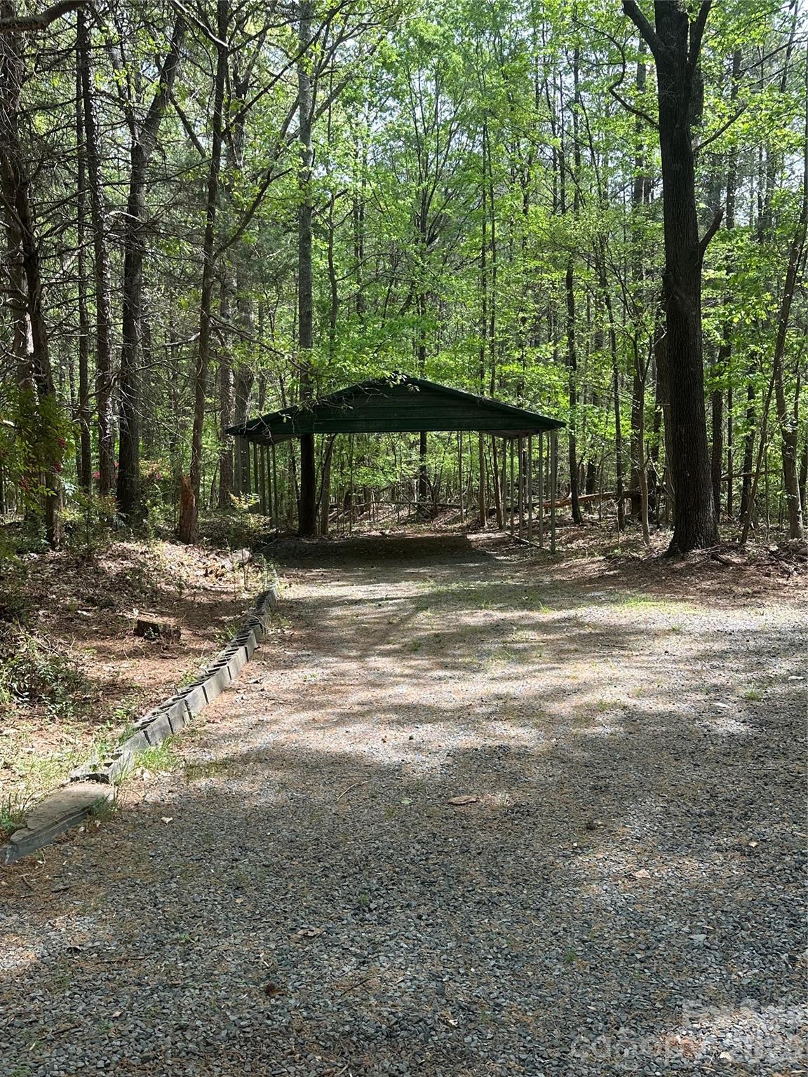 10542 Blair Road Mint Hill, NC 28227 - Photo 28 of 31 a backyard of a house with large trees and outdoor seating