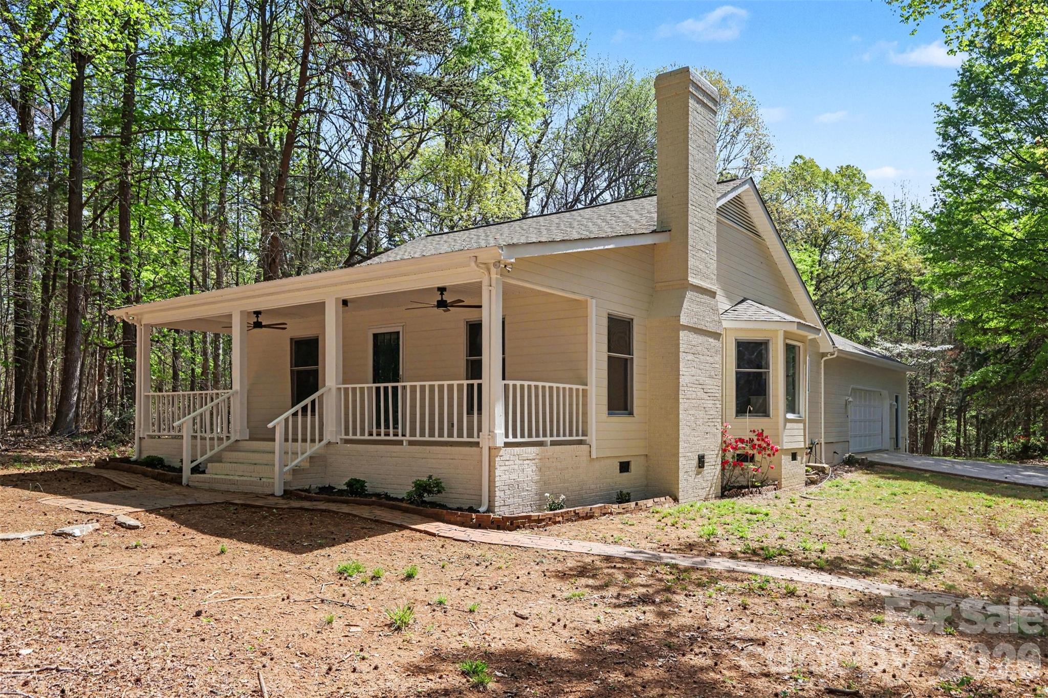 10542 Blair Road Mint Hill, NC 28227 - Photo 4 of 31 a view of a white house with a yard and large tree
