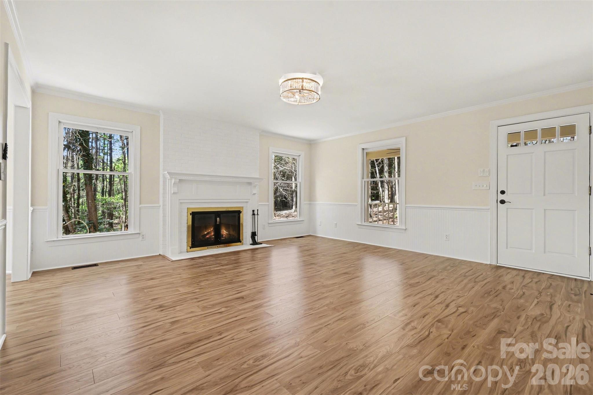 10542 Blair Road Mint Hill, NC 28227 - Photo 8 of 31 an empty room with wooden floor fireplace and windows