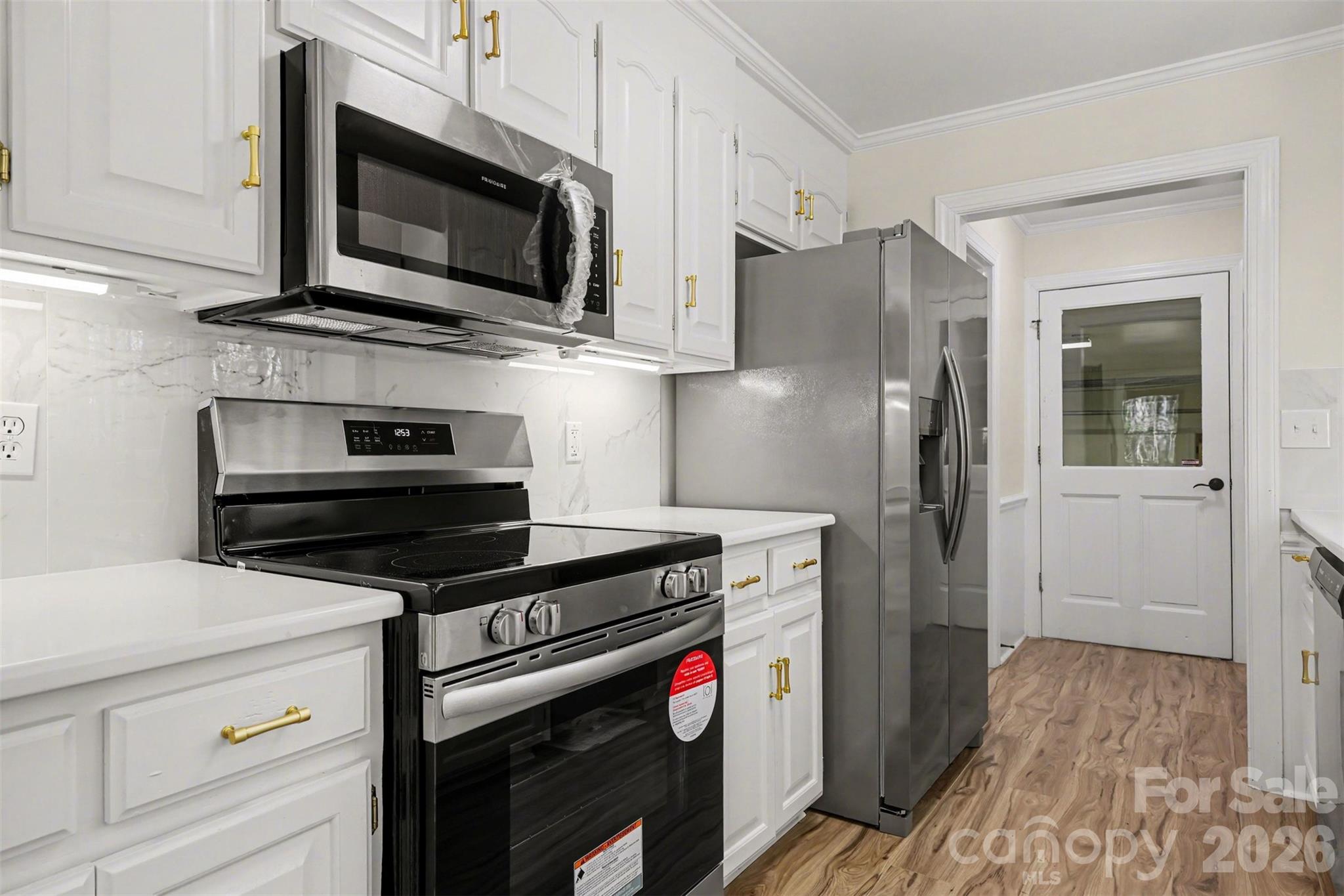 10542 Blair Road Mint Hill, NC 28227 - Photo 10 of 31 a kitchen with stainless steel appliances a stove and a microwave