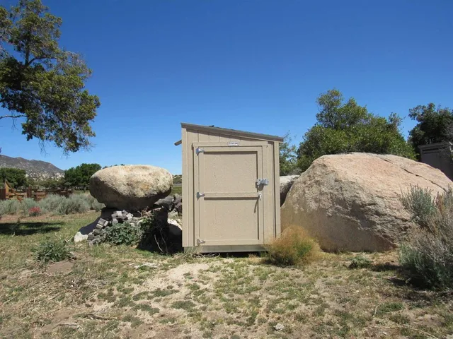 a backyard of a house with table and chairs