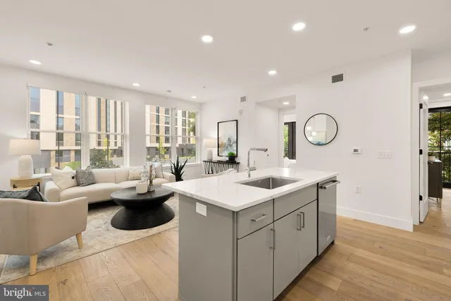 a kitchen with a sink and living room