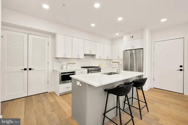 a kitchen with a refrigerator a stove a sink and a cabinets
