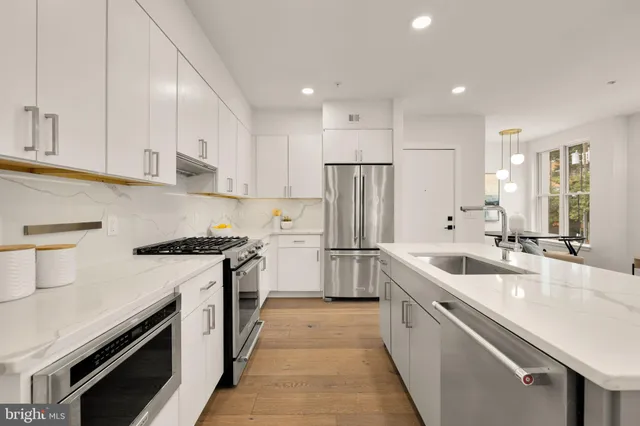 a kitchen with a sink stove and refrigerator