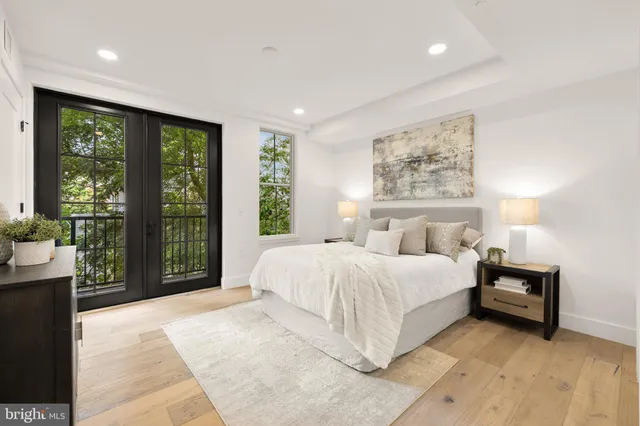 a spacious bedroom with a large bed and a large window