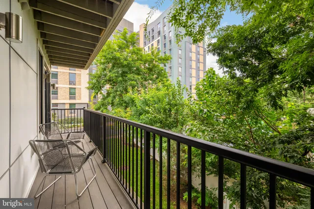 a view of a balcony with wooden floor