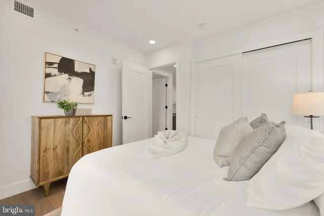 a bedroom with a bed and a mirror